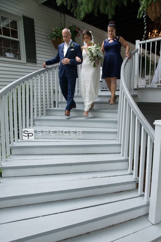 bride walking down stairs with dad