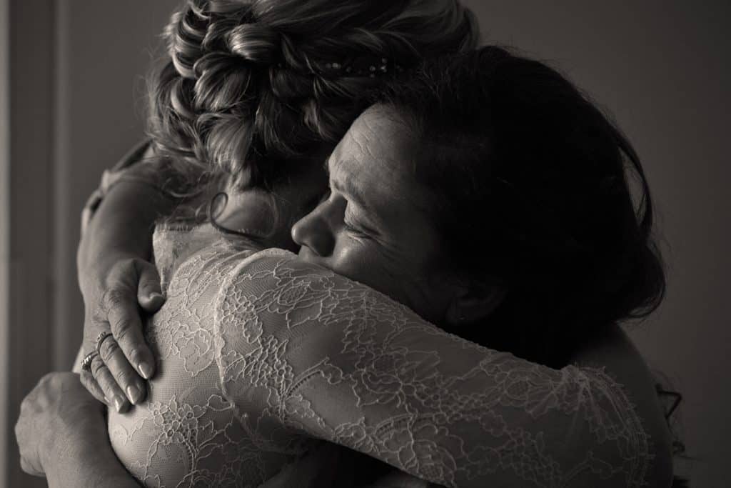mom crying and hugging bride