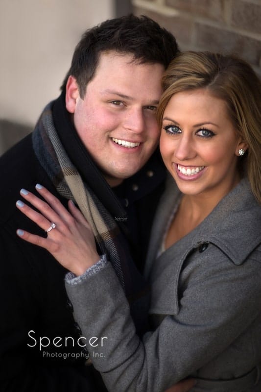 engagement picture of couple smiling into camera