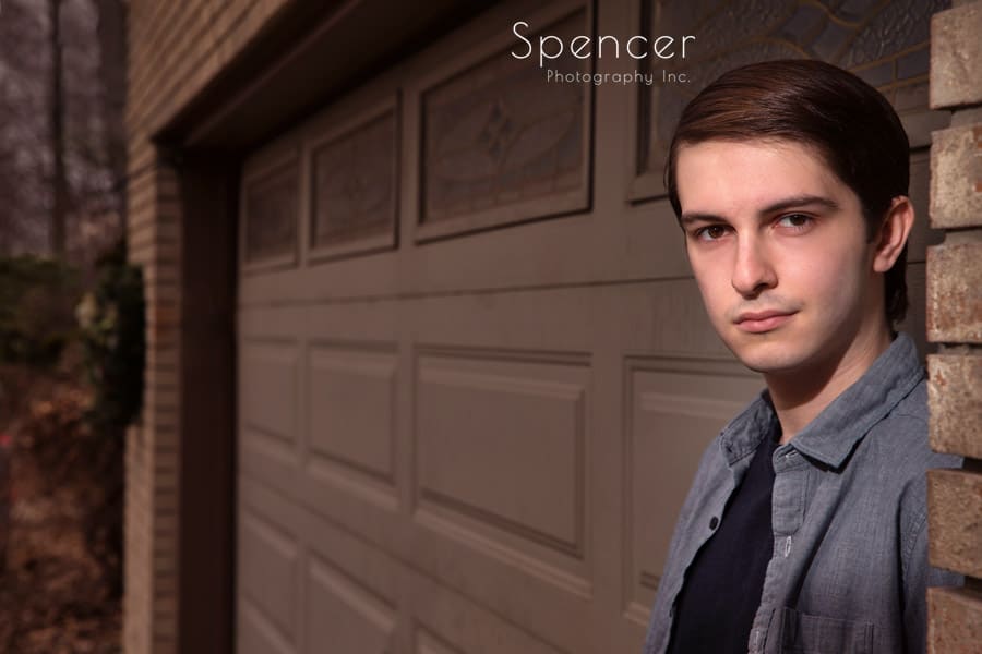 senior portrait in Manchester Ohio against a garage door