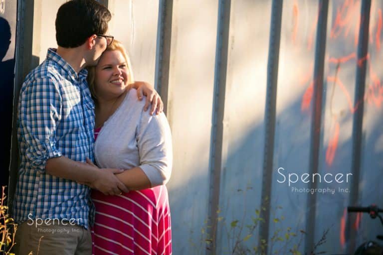man kisses woman during their engagement pictures in akron merriman valley