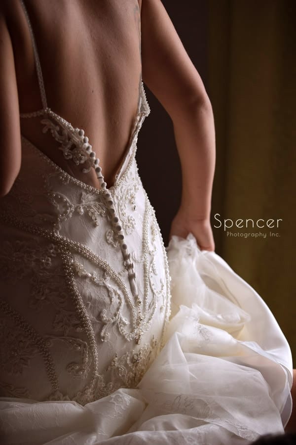 bride putting on wedding dress in Pittsburgh hotel
