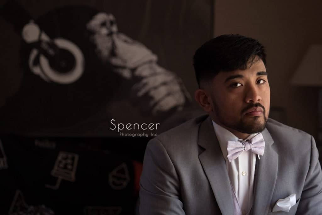 wedding day portrait of groom with a chimp picture