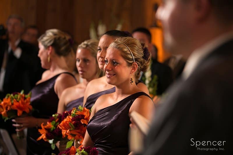 wedding party watching wedding ceremony at Brookside Farm
