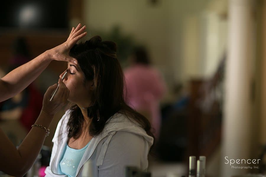 Muslim bride getting make-up before wedding