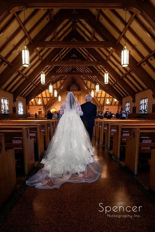 dad walking bride down wedding aisle at St. Clare Church