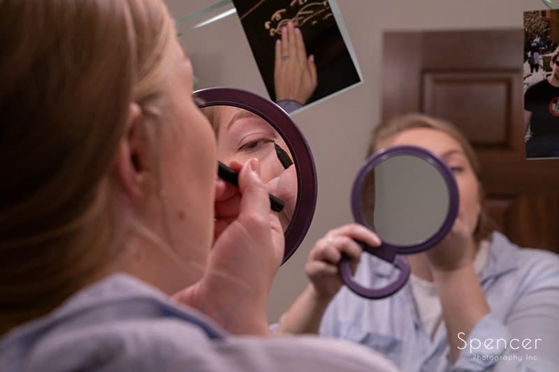 close up of maid of honor applying wedding day make up