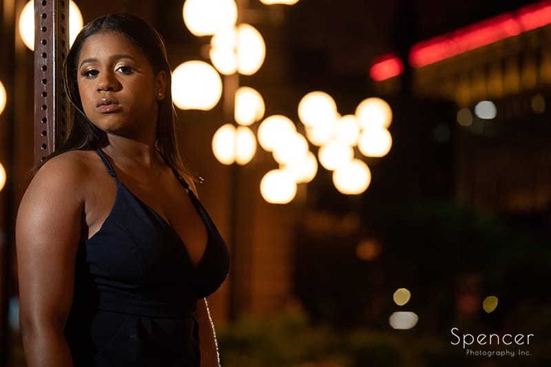 cleveland senior standing in downtown Cleveland at night