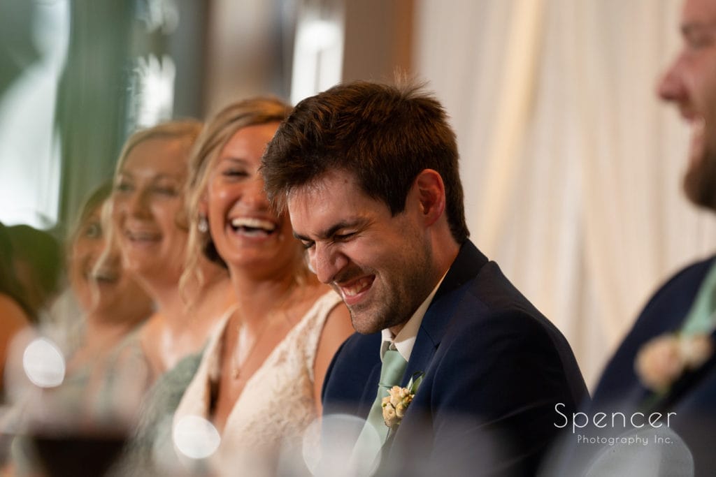groom reacting to best man speech at Firestone reception