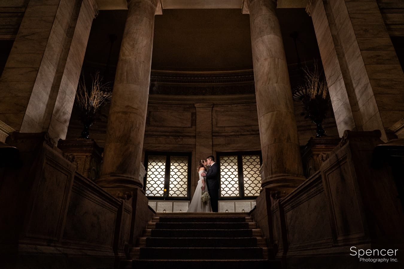 groom kissing bride at wedding at Marble Room Cleveland