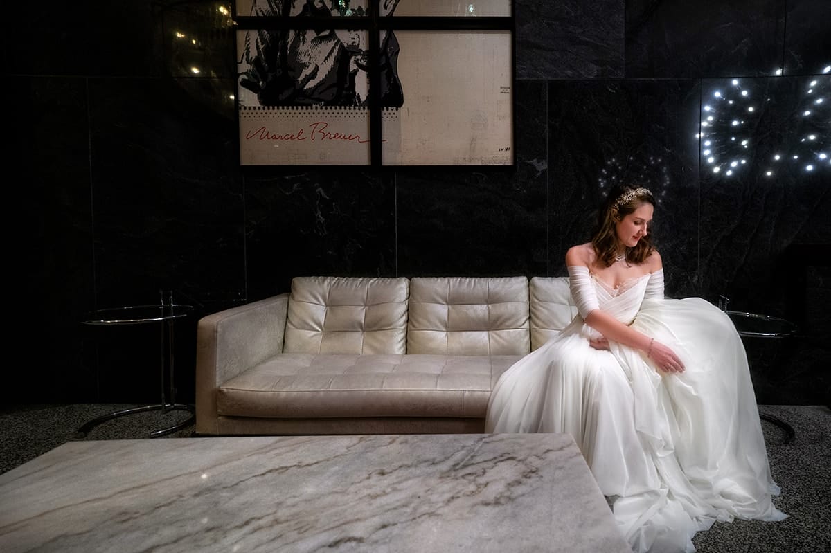 bride adjusting her wedding dress at Metropolitan at the 9jpg