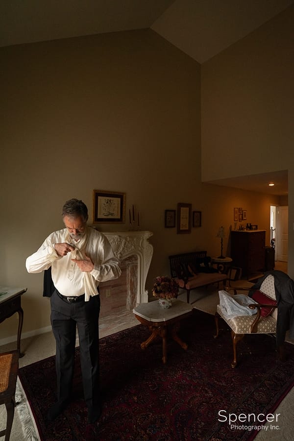 Older Groom getting dressed at O'Neil House