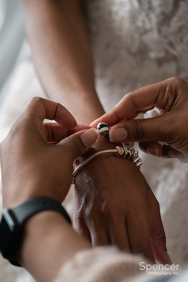 bride putting on bracelet at park lane villa