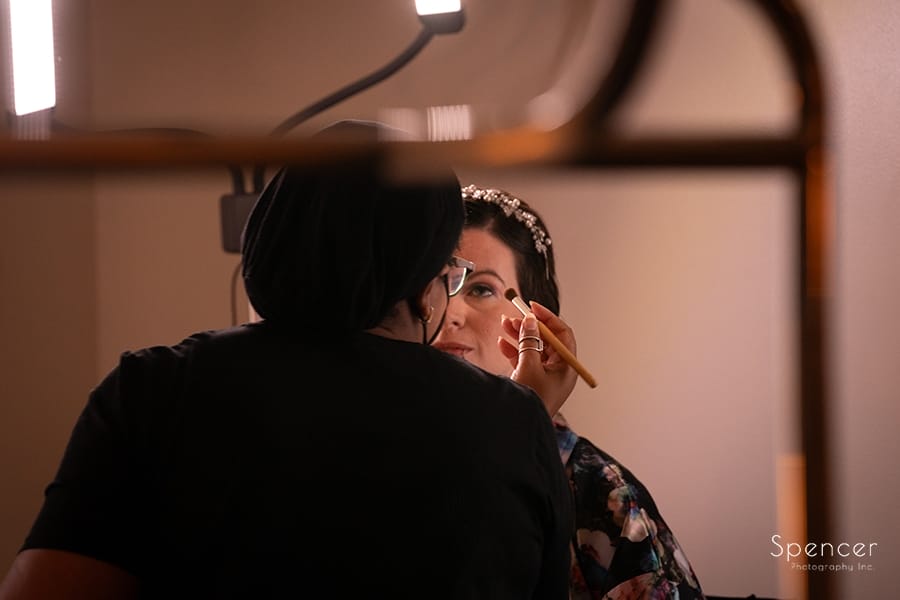 bride getting wedding make-up at Akron Marriott
