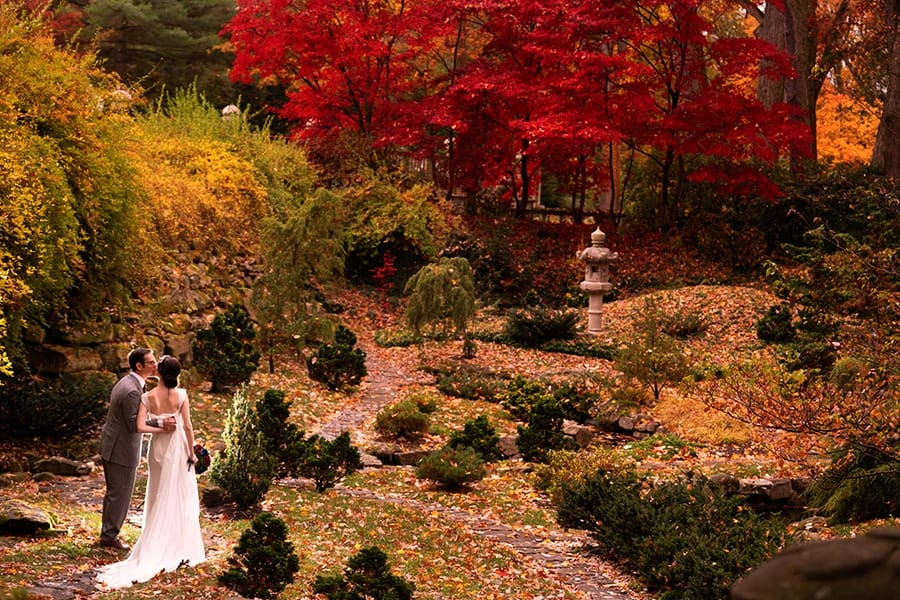 bride and groom kissing in the Japanese Garden before their wedding at Stan Hywet in Akron Ohio