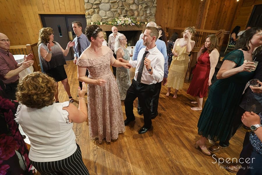 bride and groom dancing with guest at Mapleside Farms wedding reception